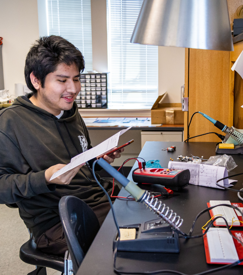 student building electric car in lab class