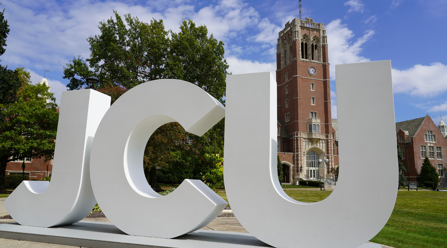 jcu campus with JCU letters in front of clock tower