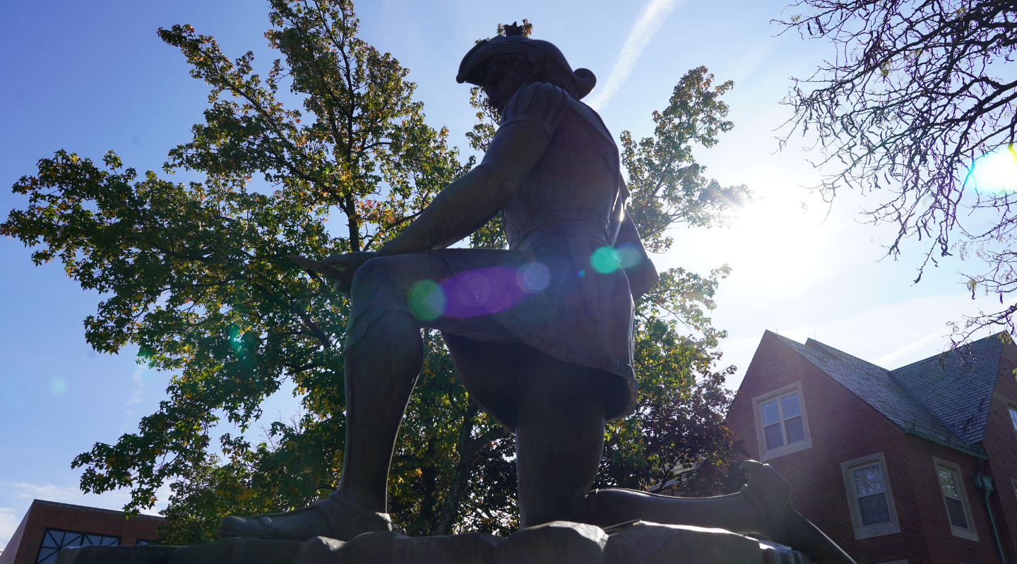 saint ignatius statue on campus kneeling in the sunlight