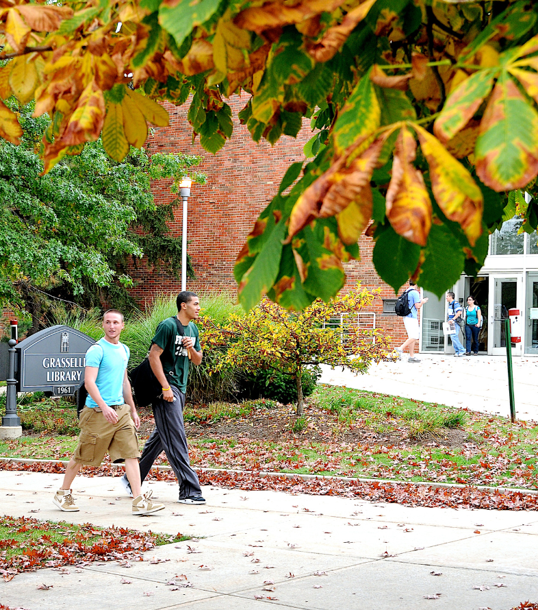 students walking in front of library