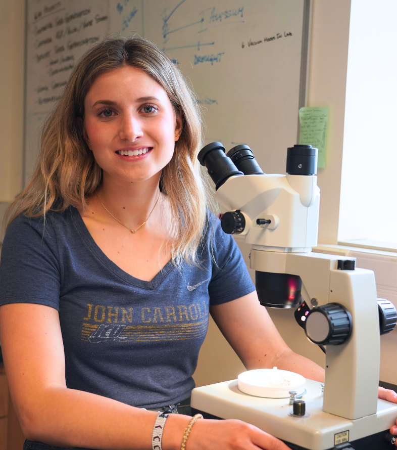 student with microscope