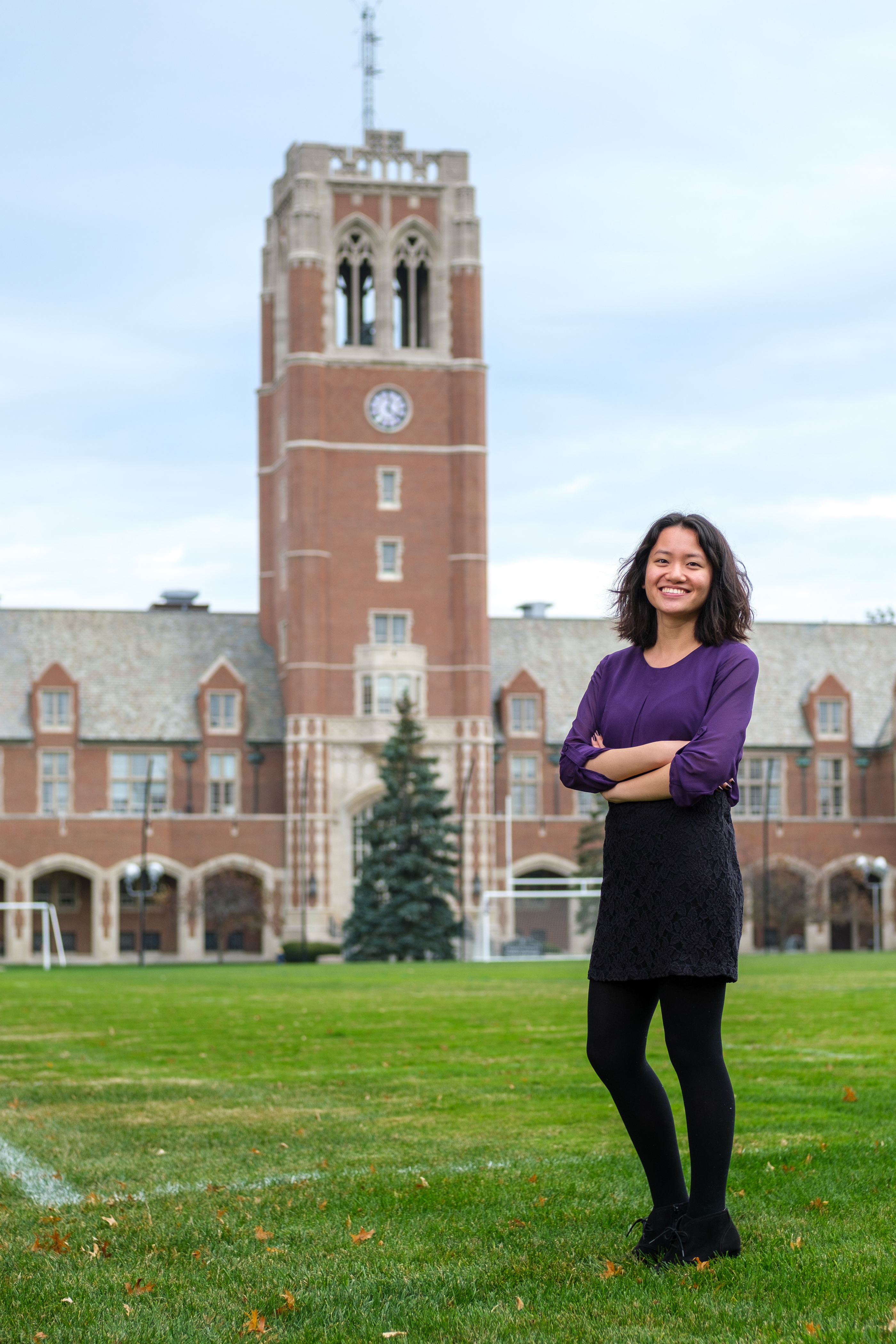 graduate school student in front of jcu clock tower