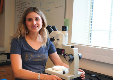 girl with microscope in classroom