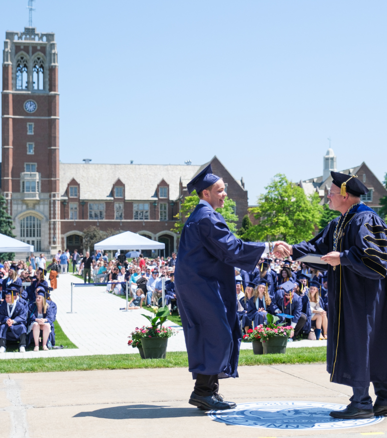 student shaking president's hand at commencement