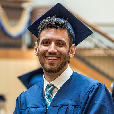 Picture of counseling male student at graduation_Andre R.