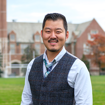 Picture of Counseling graduate student Yub K. in front of St. Ignatius Hall