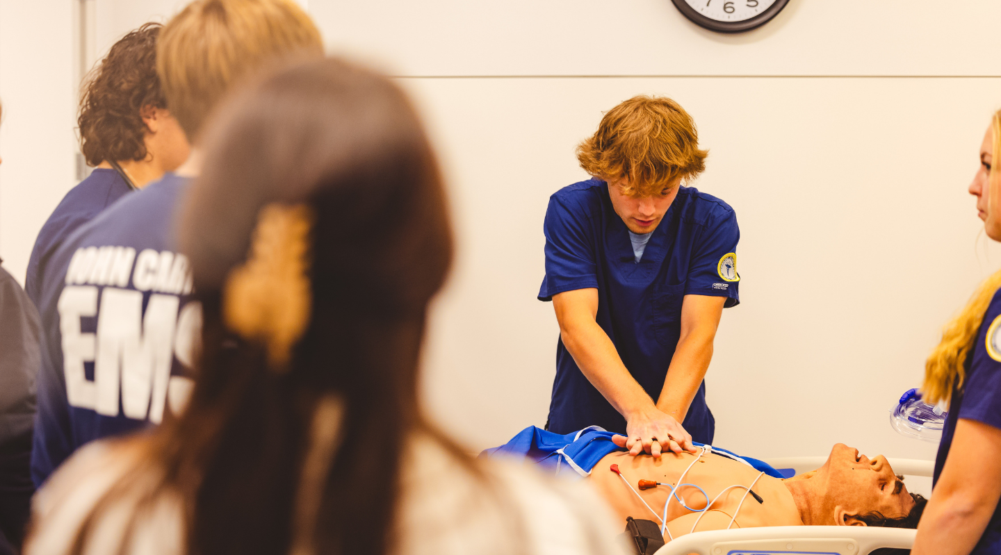 healthcare career foundations student performing cpr on manniquin