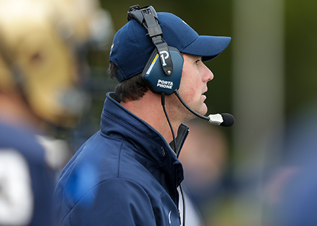 Male football coach on sidelines at a game