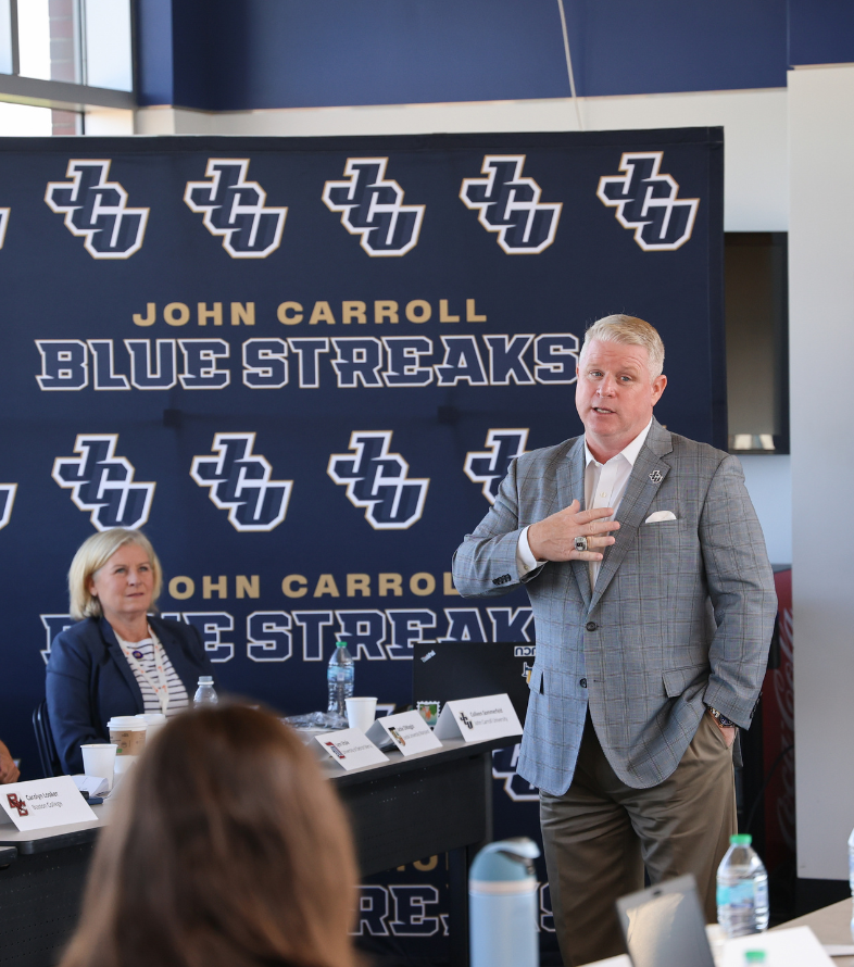 brian polian speaking in jcu stadium press box