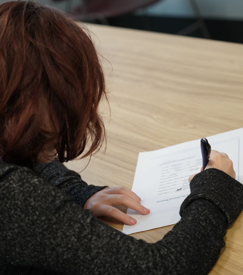 student writing on paper