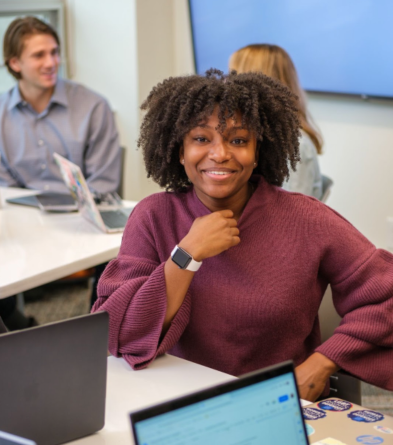 grad student in classroom smiling at camera