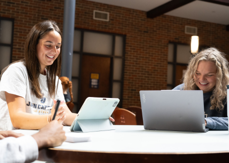 female students at laptops