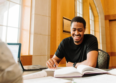 male student reading books