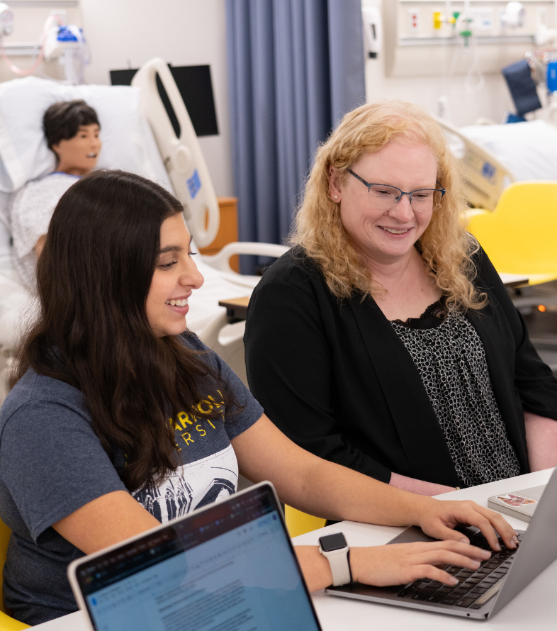 jcu pre health student meeting with female faculty member in lab