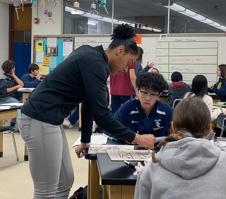 Female Teacher helping middle school student