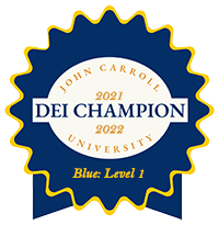 Dark blue award badge reads 2021-2022 DEI Champion John Carroll University Blue - Level 1