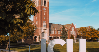 JCU campus with tower and white letters in foreground