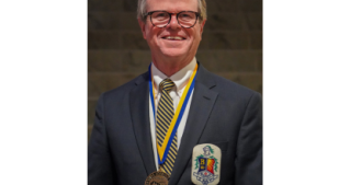 Dave Robinson Posing During the John Carroll University Alumni Medal Ceremony