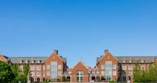 Photo of the front of John Carroll University's red brick campus. 