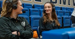 WJCU’s Nikolena Samac ’27 (on the right) broadcasting a JCU basketball game