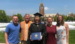 Colleen Corrigan Day stands on the quad with her family on commencement day