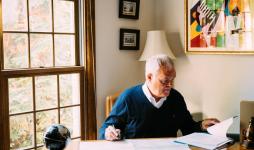 Bill O’Rourke sits at the desk in his home office