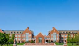 Photo of the front of John Carroll University's red brick campus. 