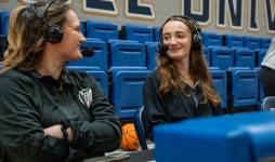 WJCU’s Nikolena Samac ’27 (on the right) broadcasting a JCU basketball game