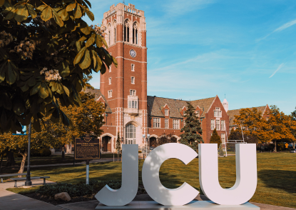 JCU campus with tower and white letters in foreground