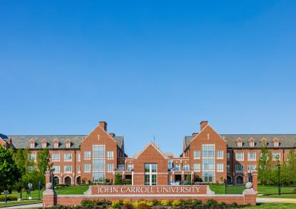 Photo of the front of John Carroll University's red brick campus. 